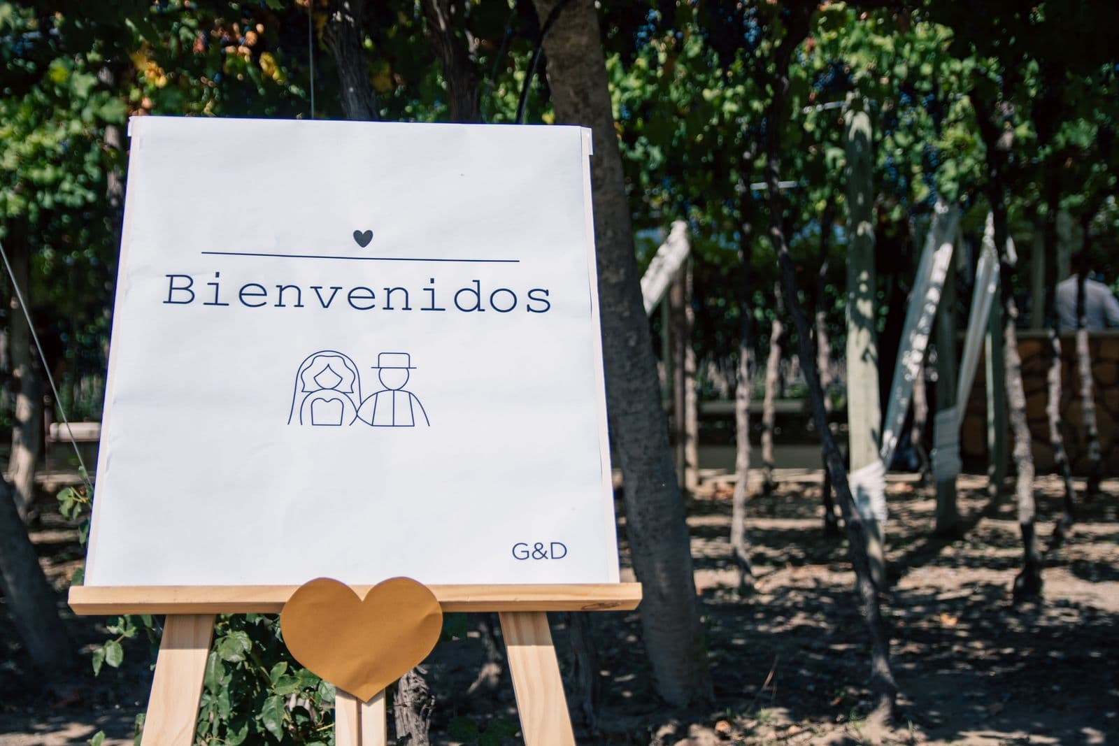 Wedding welcome sign at an outdoor ceremony entrance