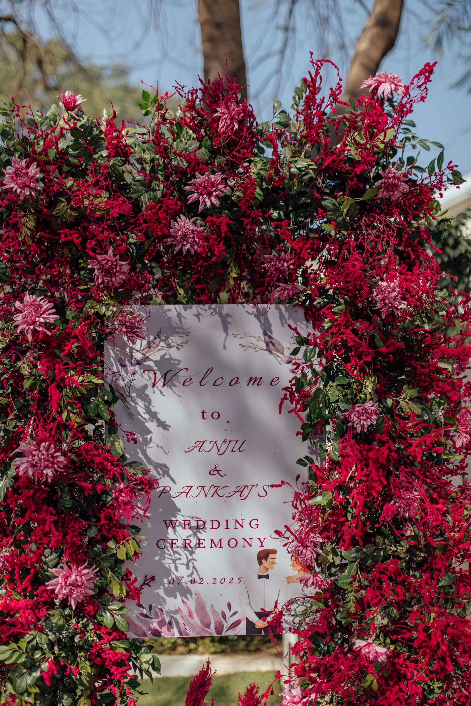 Floral wedding welcome sign with red accents